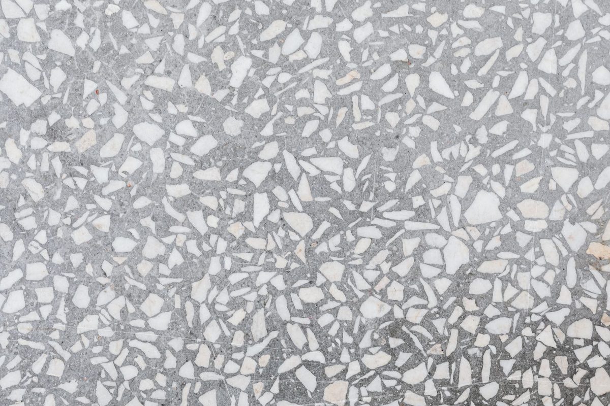 Close-up of a speckled gray and white stone chip floor surface