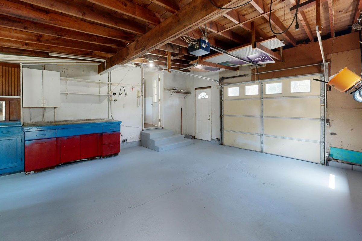 Residential garage interior with a light gray coated concrete floor