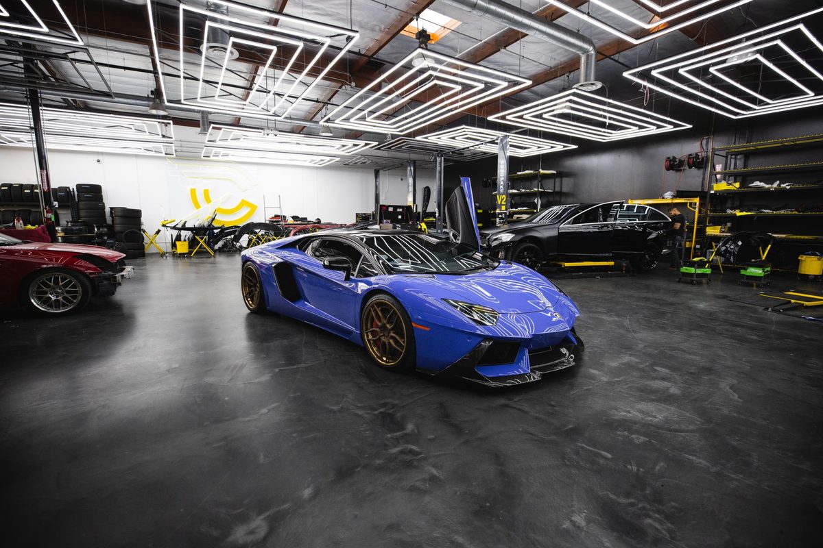 Glossy dark coated garage floor with sports cars parked on it