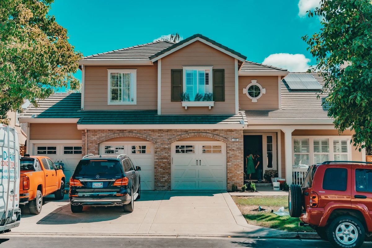 Suburban street of homes with attached garages and parked vehicles