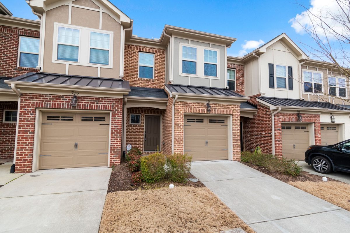 Row of brick townhomes with attached garages