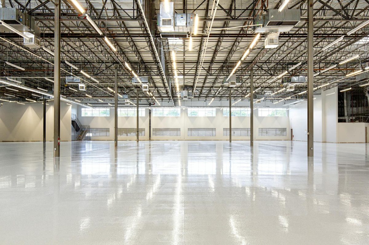Polished light gray floor in an open warehouse interior