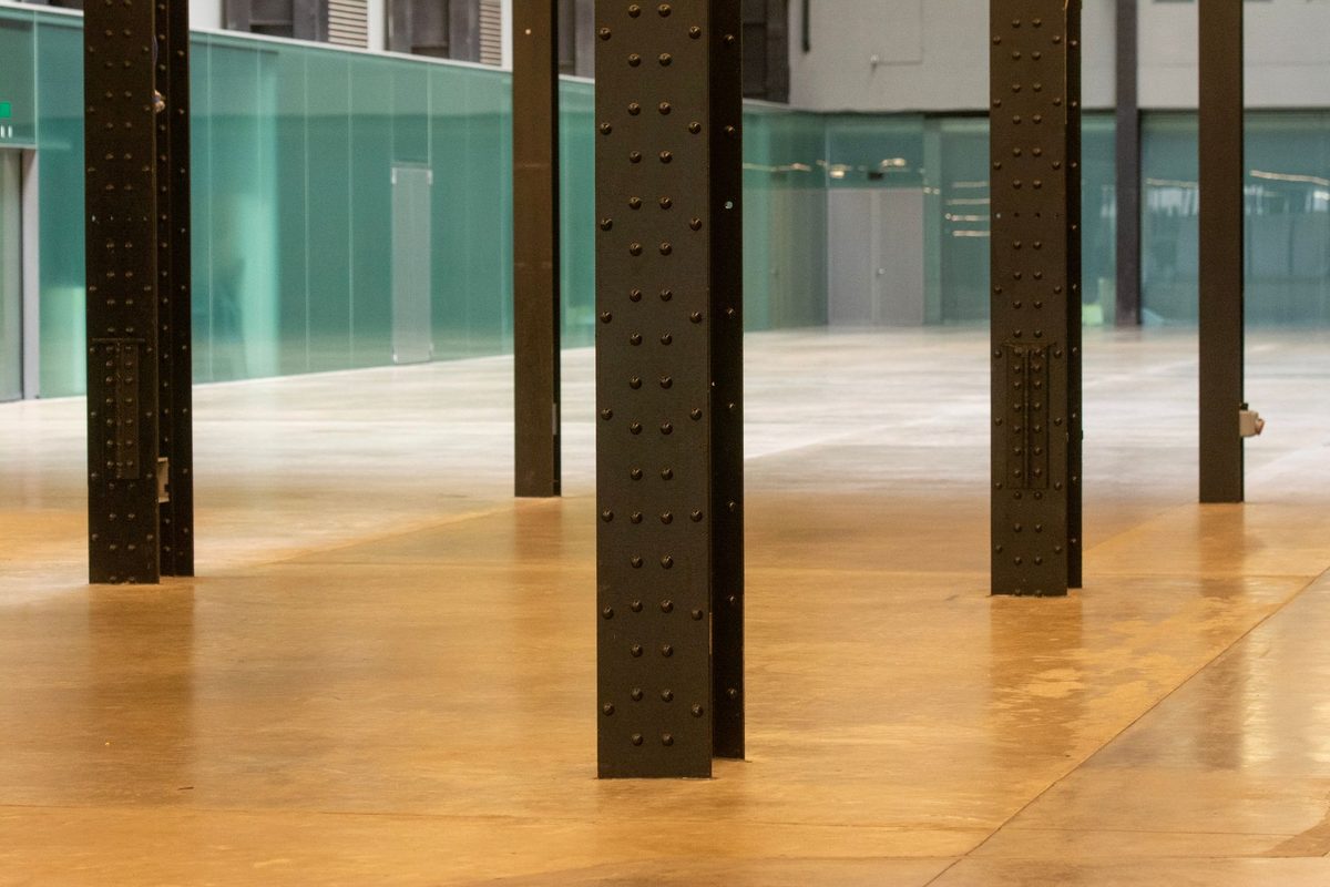 High-gloss amber resin floor in an open industrial interior